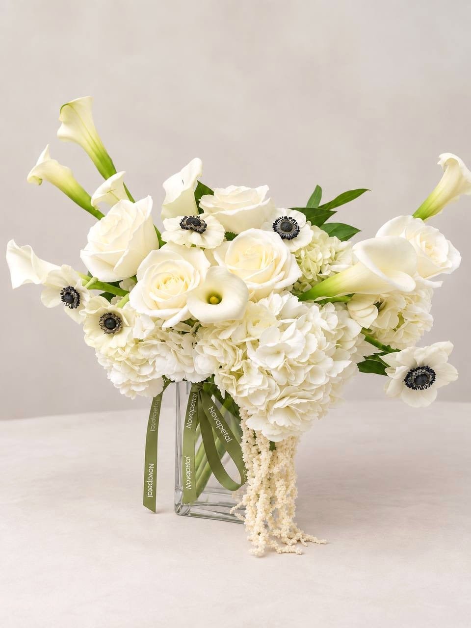 Calla Noir large: white calla lilies, anemones with black centers, hydrangea and cream roses in a glass vase, Phoenix flower delivery