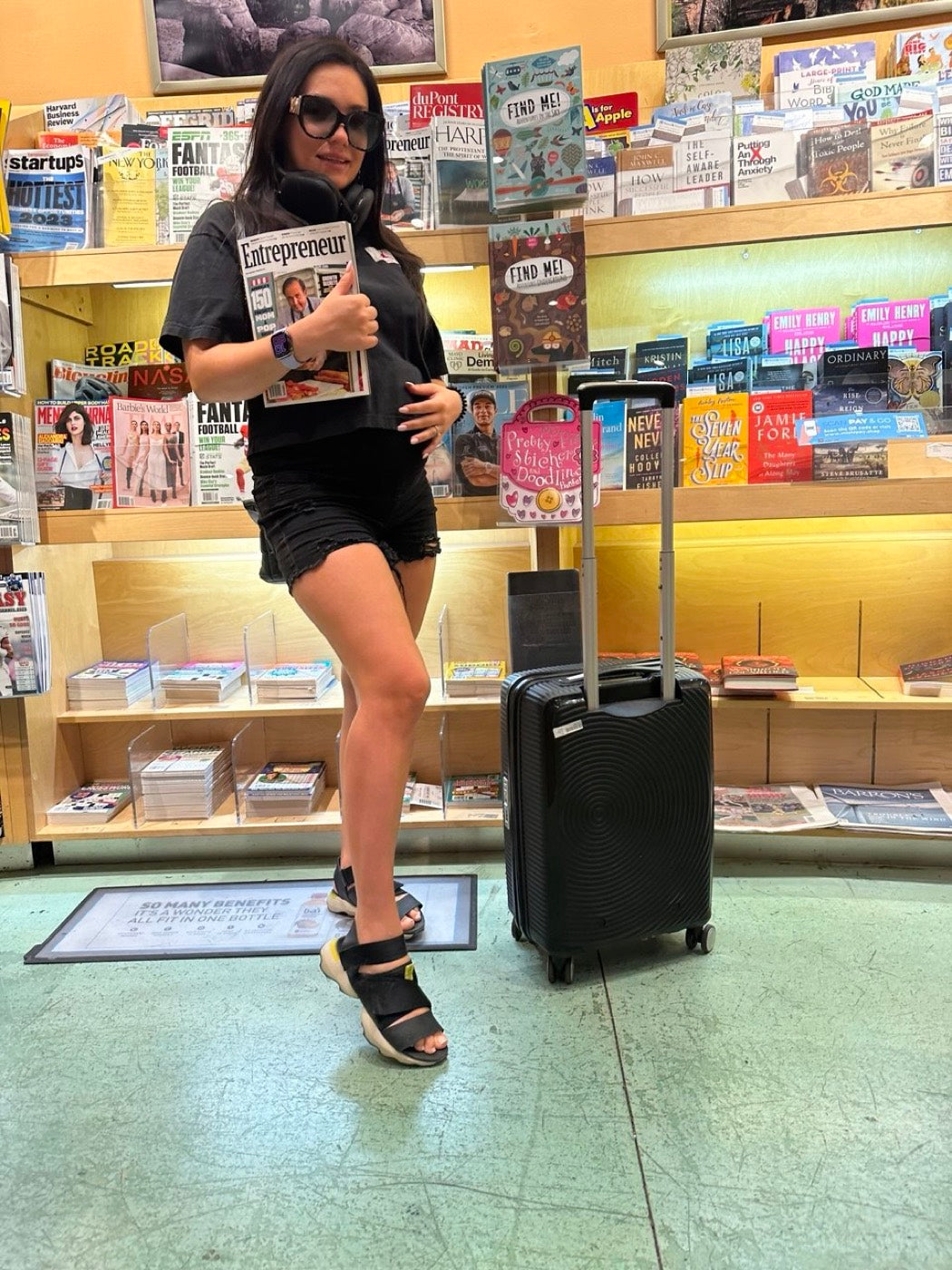 Novapetal cofounder holding the July/August 2023 issue of Entrepreneur magazine, the issue that named the shop to America&rsquo;s Favorite Mom and Pop Shops