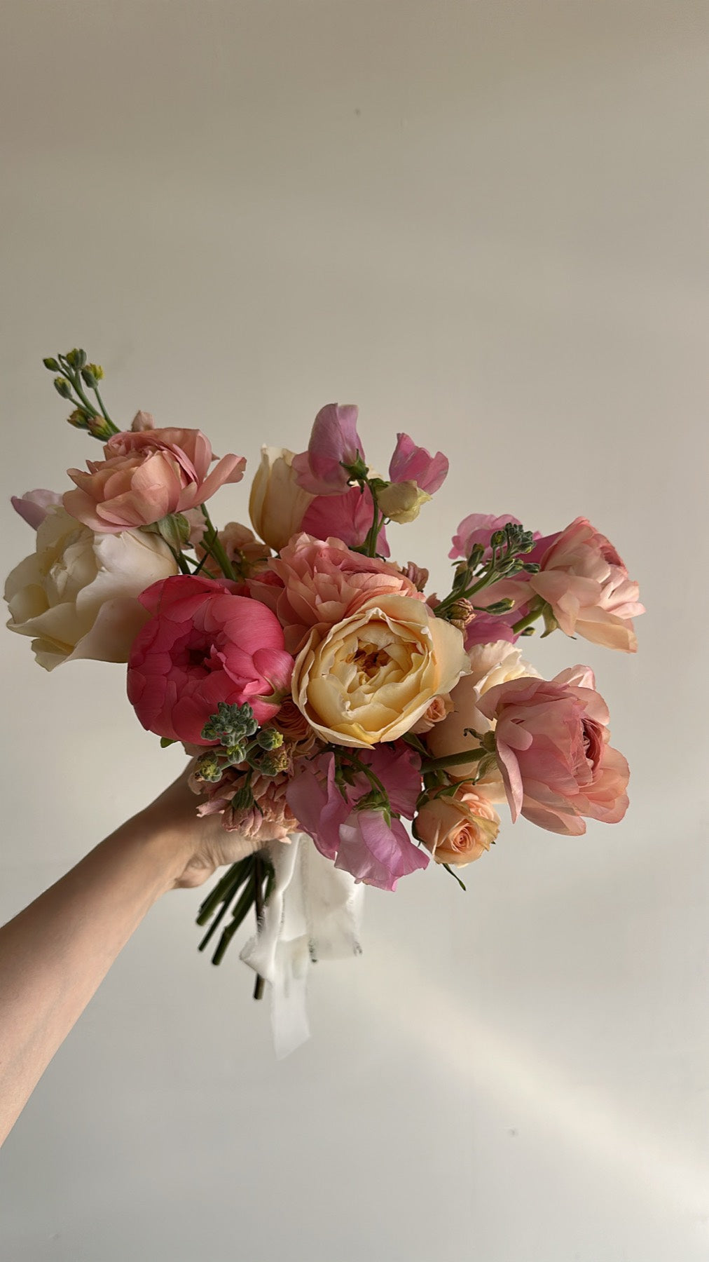 Blush and coral garden rose bridal bouquet by Novapetal with sweet pea and stock